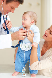 padeatrician checks baby