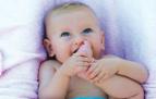 baby with toe in mouth